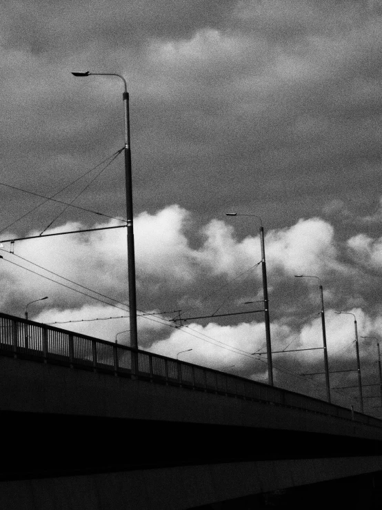 a bridge and its traffic light against a dark sky