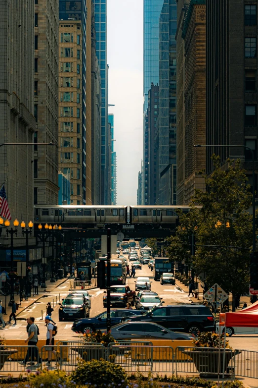 the street with cars, a bus and people walking by