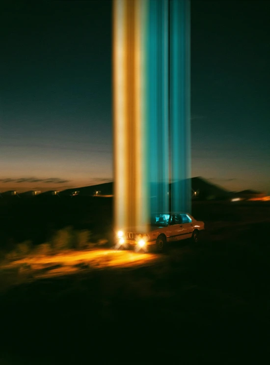 a tall structure stands in the night with bright lights shining on it