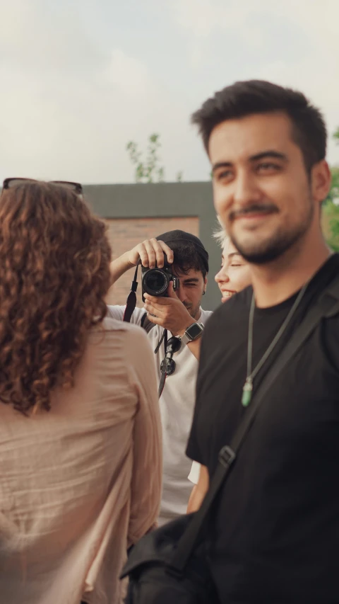 a group of people standing around each other