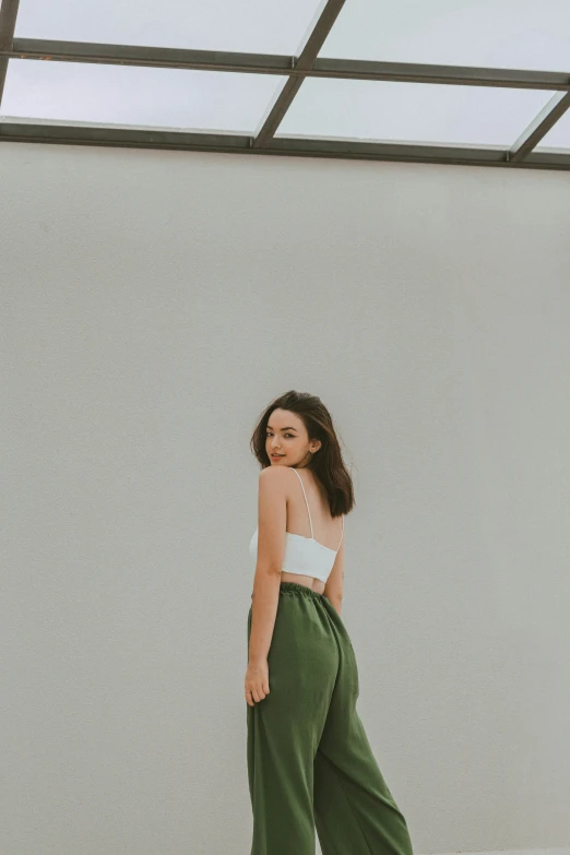 woman standing with side and back view of a crop top