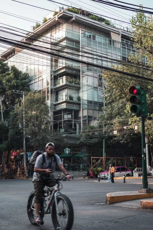 a man riding a bike down the middle of a street