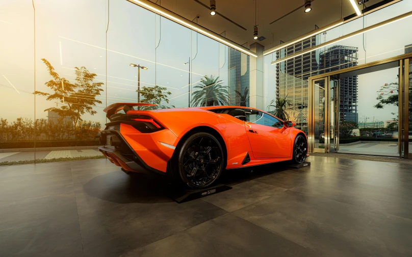 a lamb car is parked inside a large glass building