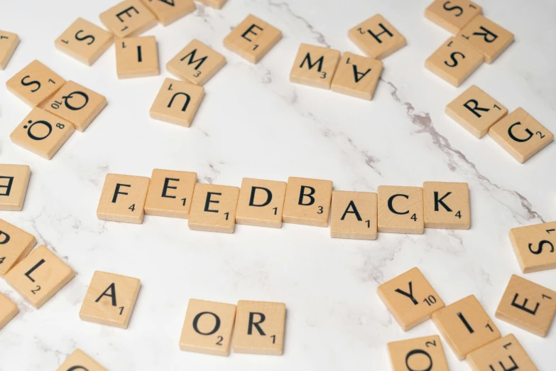 scrabbled letter tiles spelling out the words'back, yard, or shop '