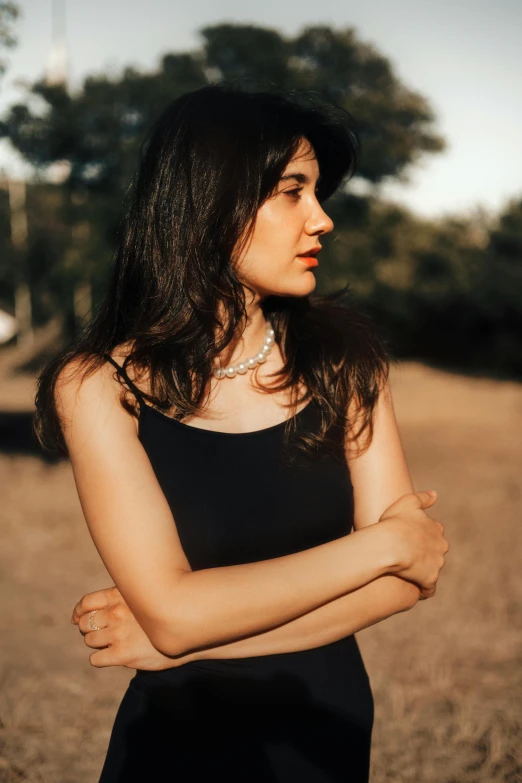 a woman wearing black poses for a picture