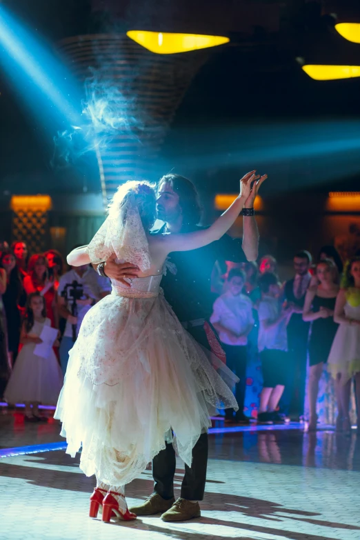 a bride and groom perform their first dance at their wedding reception