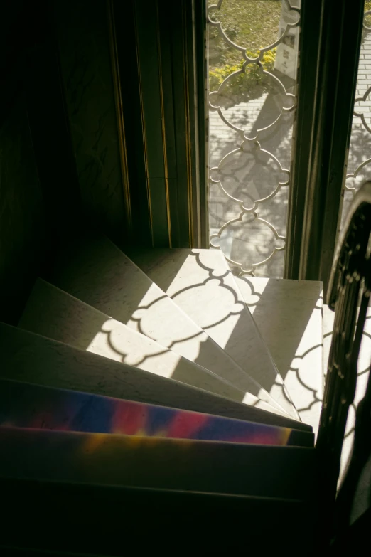 a stair case with sunlight filtering through the window