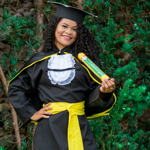 a woman in graduation gown with graduate's hat and gown