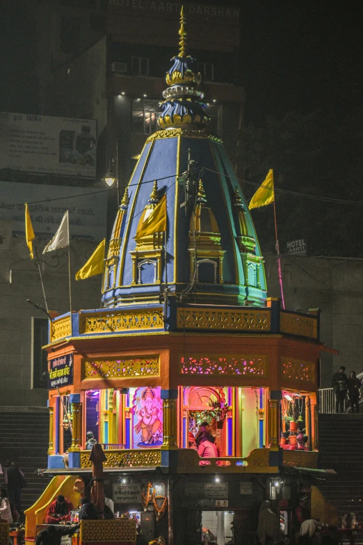 brightly lit building in large city at night