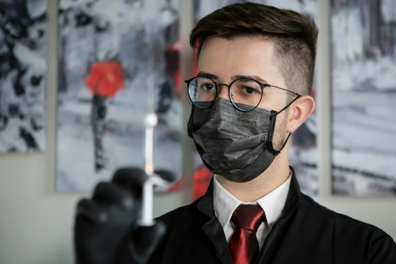 a person wearing glasses wearing a face mask