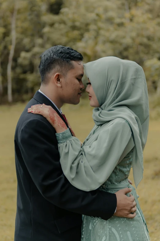 a young couple emcing on a hillside in the middle of nowhere