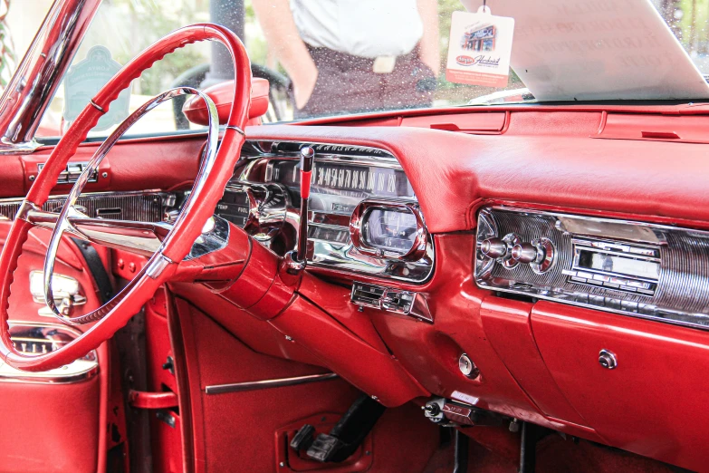 an old fashioned red car with the dashboard up