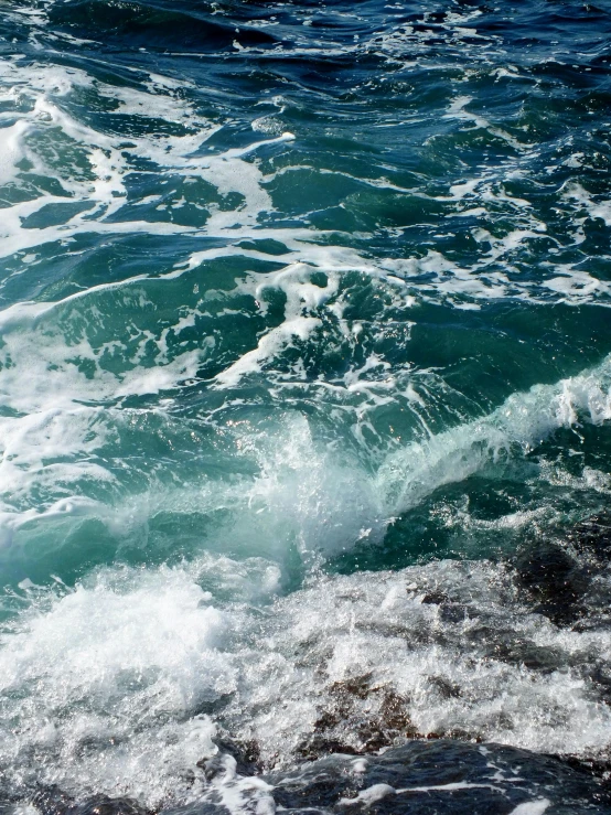 close up of waves crashing in to the beach