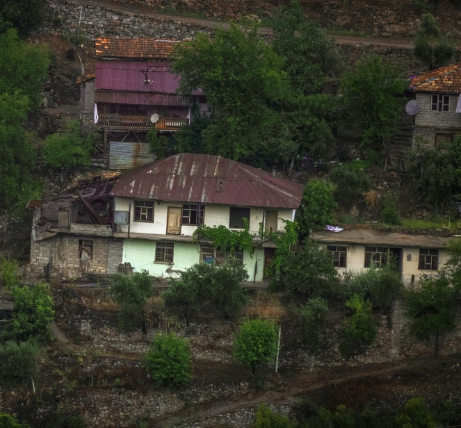 a small house in the middle of a forested area