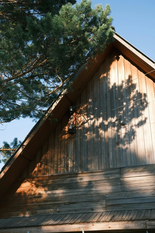 the top of a large wooden building with two trees near it