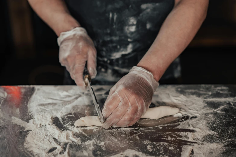 a man with white gloves on  dough
