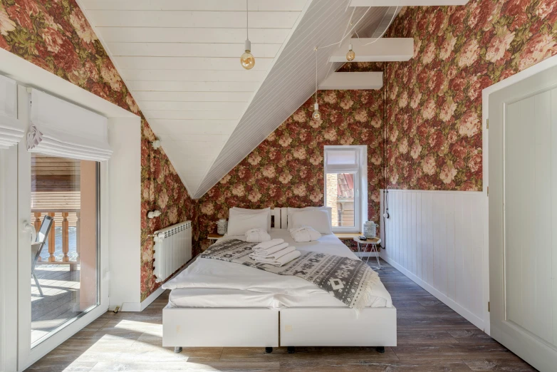 the bedroom features a white bed and a long wooden floor