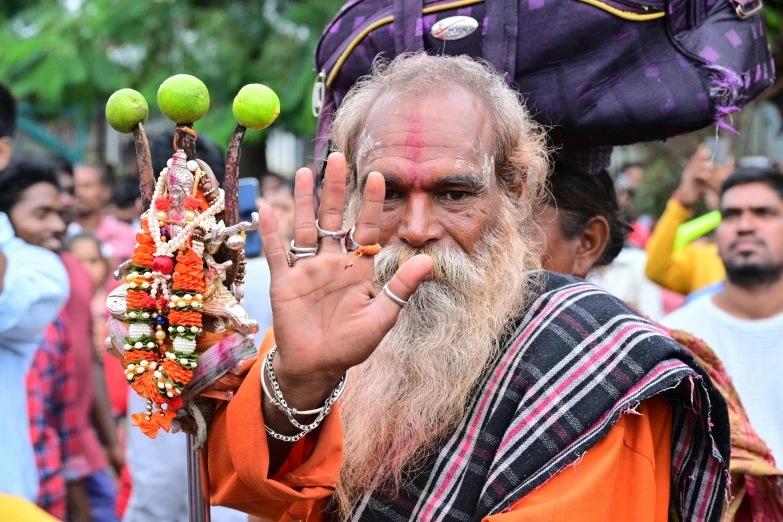 a man wearing a hat, with balls and garlands in front of him