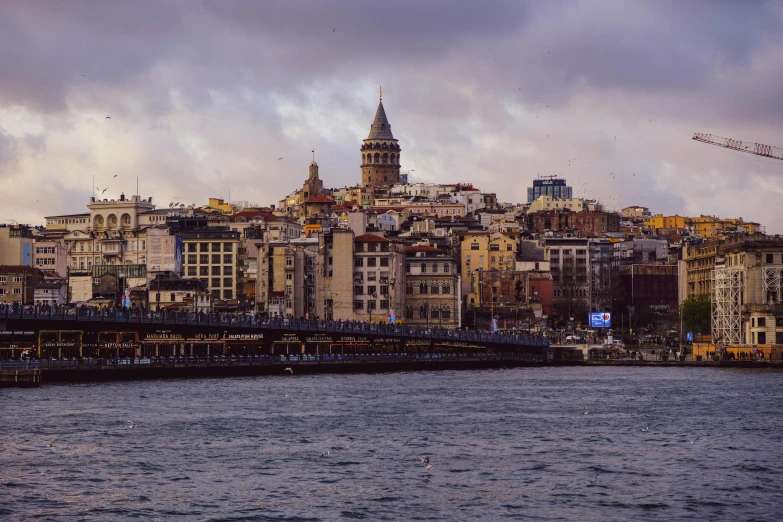 a city by the sea with buildings on the side and water