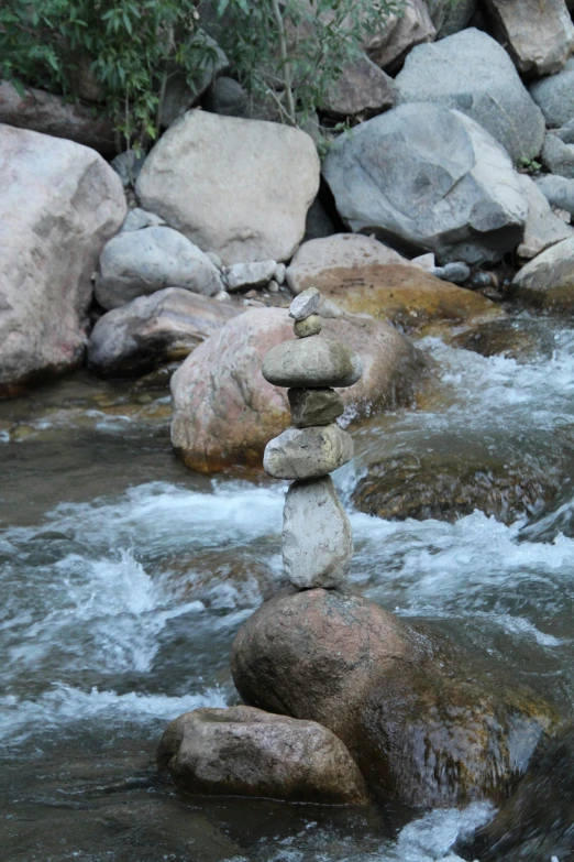 a stack of rocks is placed on top of water
