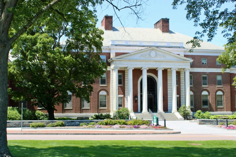 the front of a large building with columns and arches