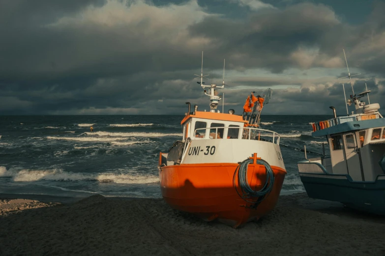 two boats are on the beach next to the ocean