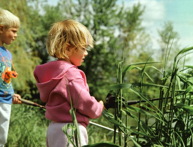 two s play in the grass near the woods