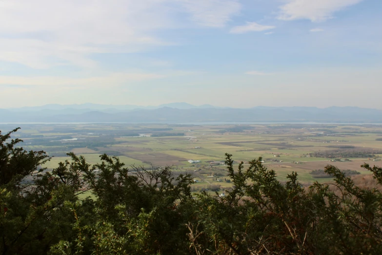 a view of some mountains and fields from above