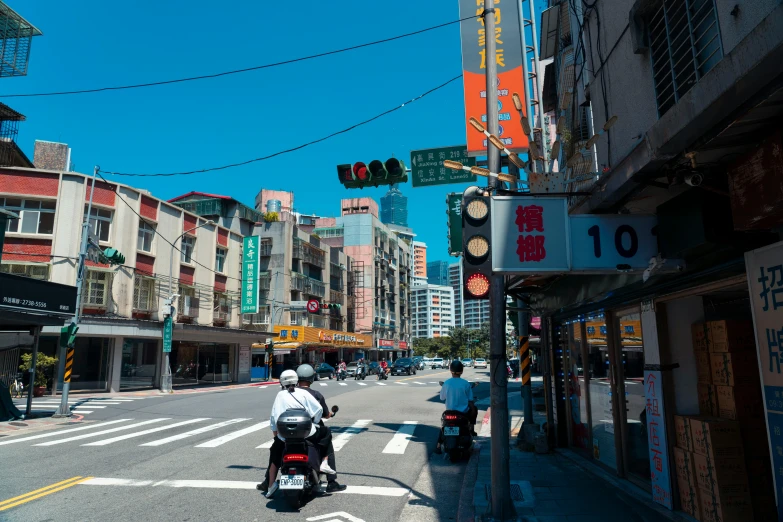 a man riding a motorcycle down a street