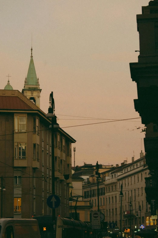 an old building with a tower on top in a city