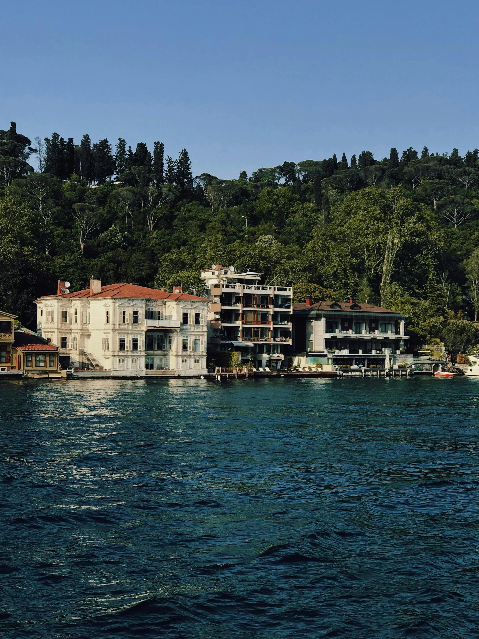 houses are on a mountain overlooking the water