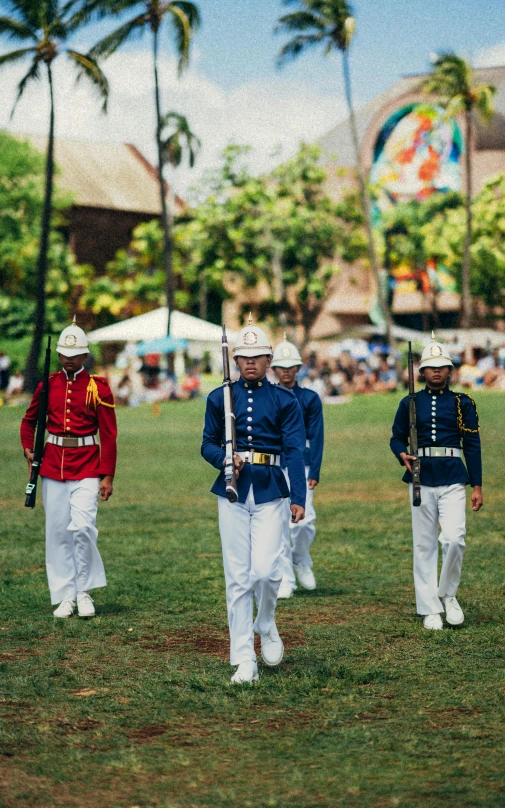 a group of men in uniforms stand around as others walk