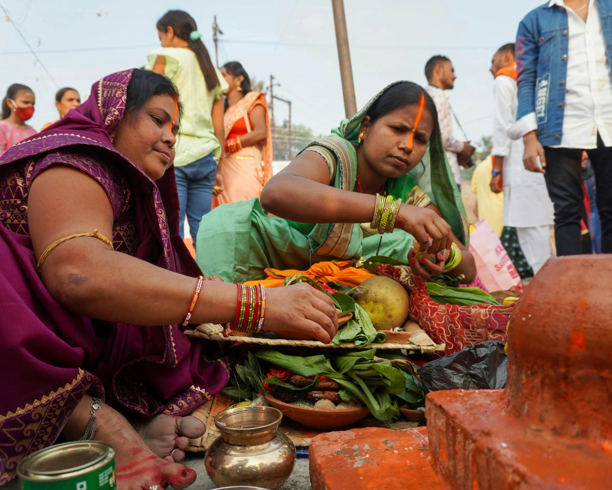 some people getting food out of a bowl