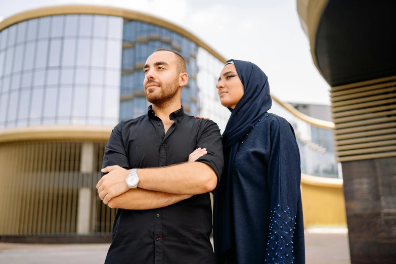 two men stand in front of a building