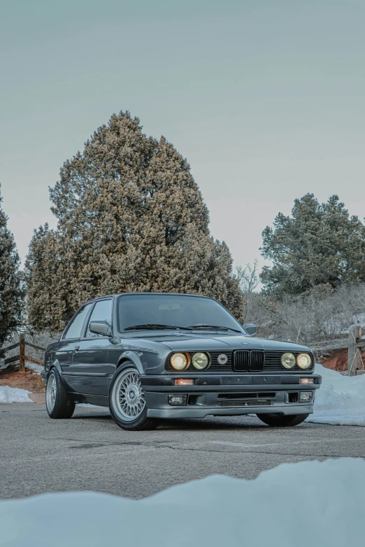 an old black car is parked in a driveway