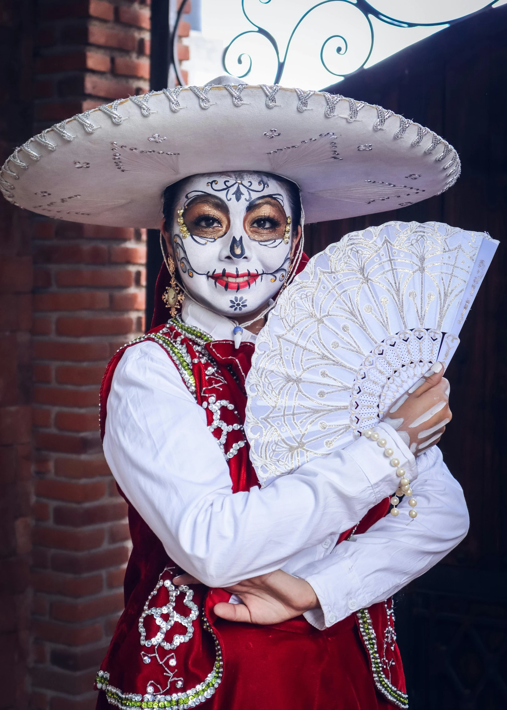 a girl dressed in a mexican costume and makeup