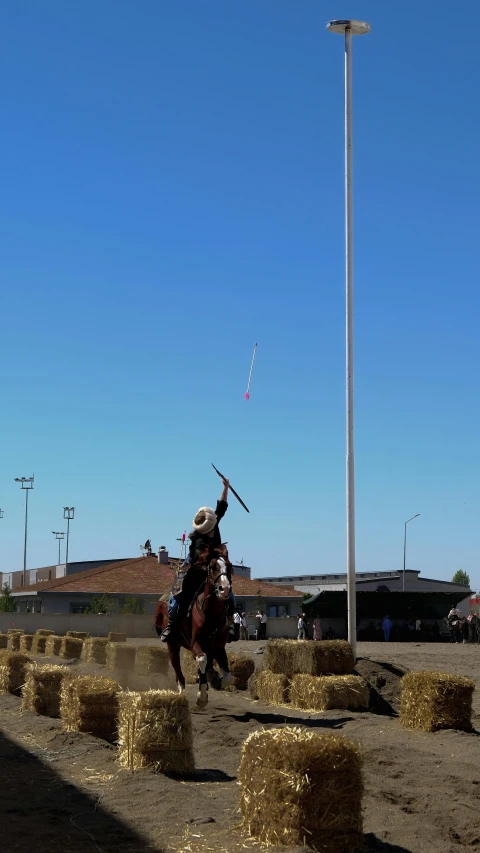 two cowboys are playing with their horses at the rodeo