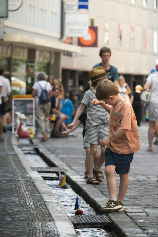 there are people on the sidewalk playing with toys