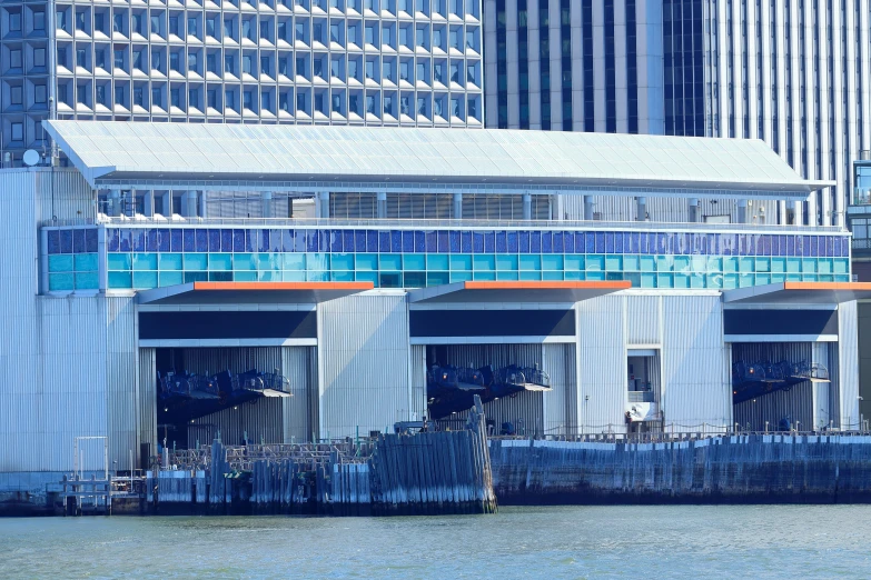 some buildings are sitting in the water and one has a clock on it