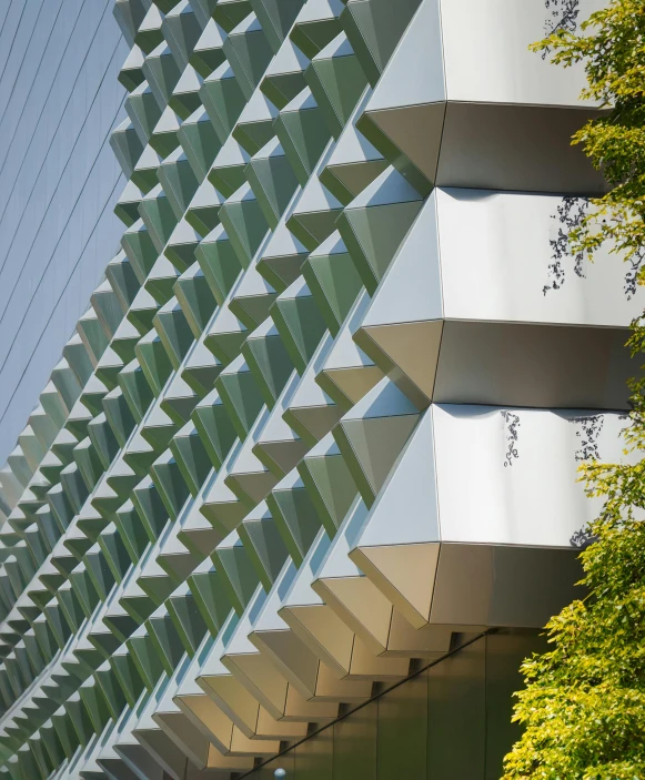 the building is made up of an angled glass and steel structure