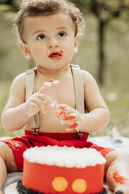 a baby boy getting ready to cut his cake