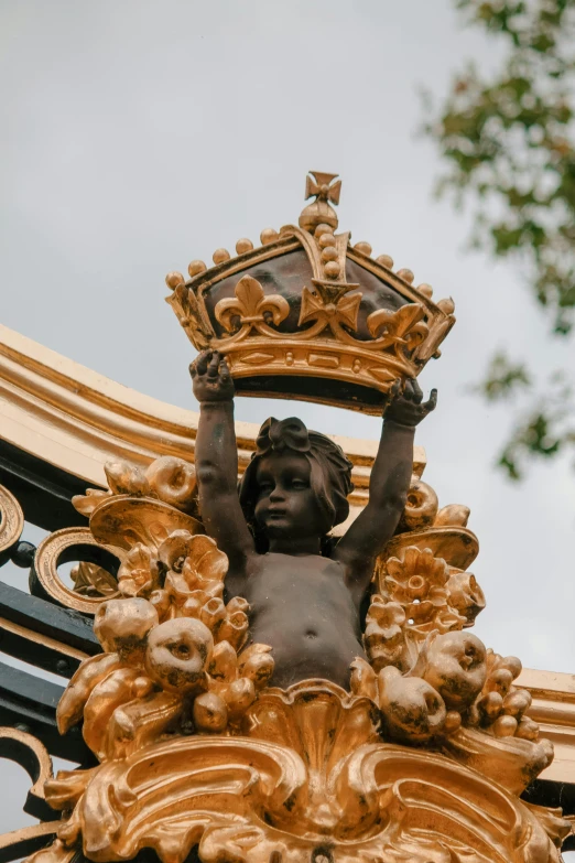 a statue is holding a crown above its head