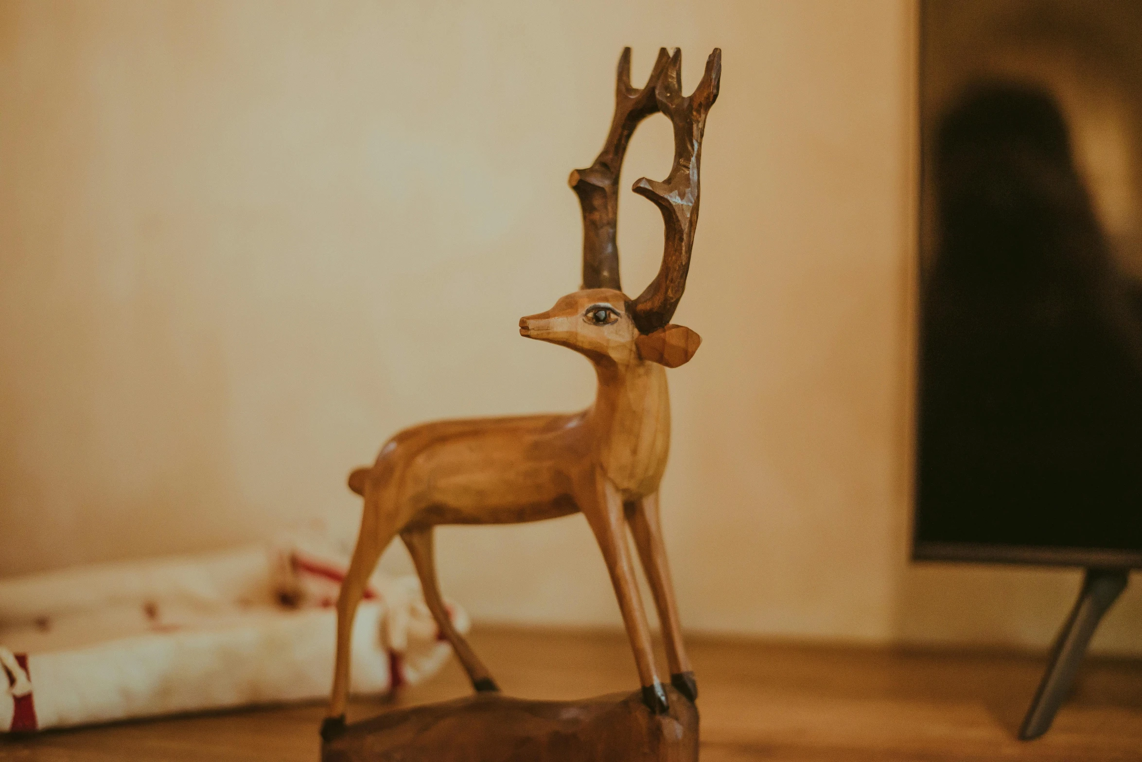 deer figurine on wooden floor next to chair