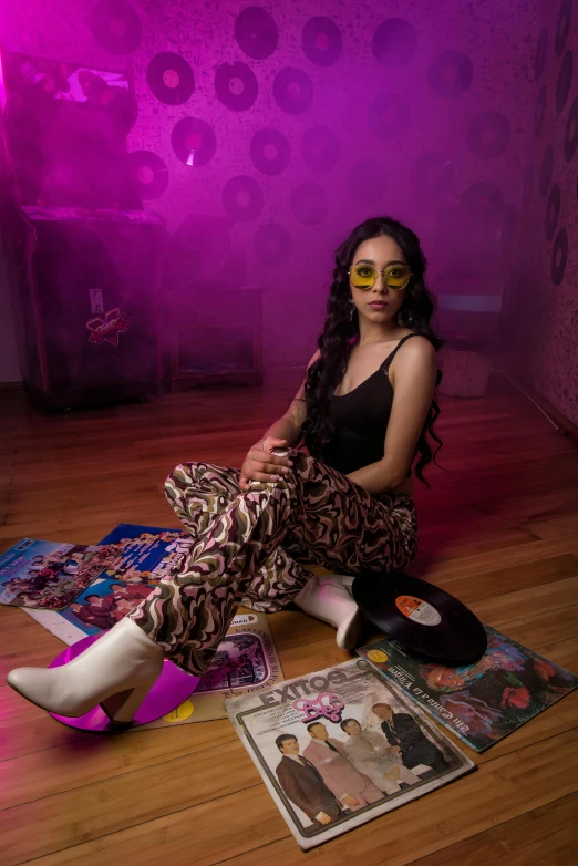 a woman is sitting on the floor with her shoes and magazine