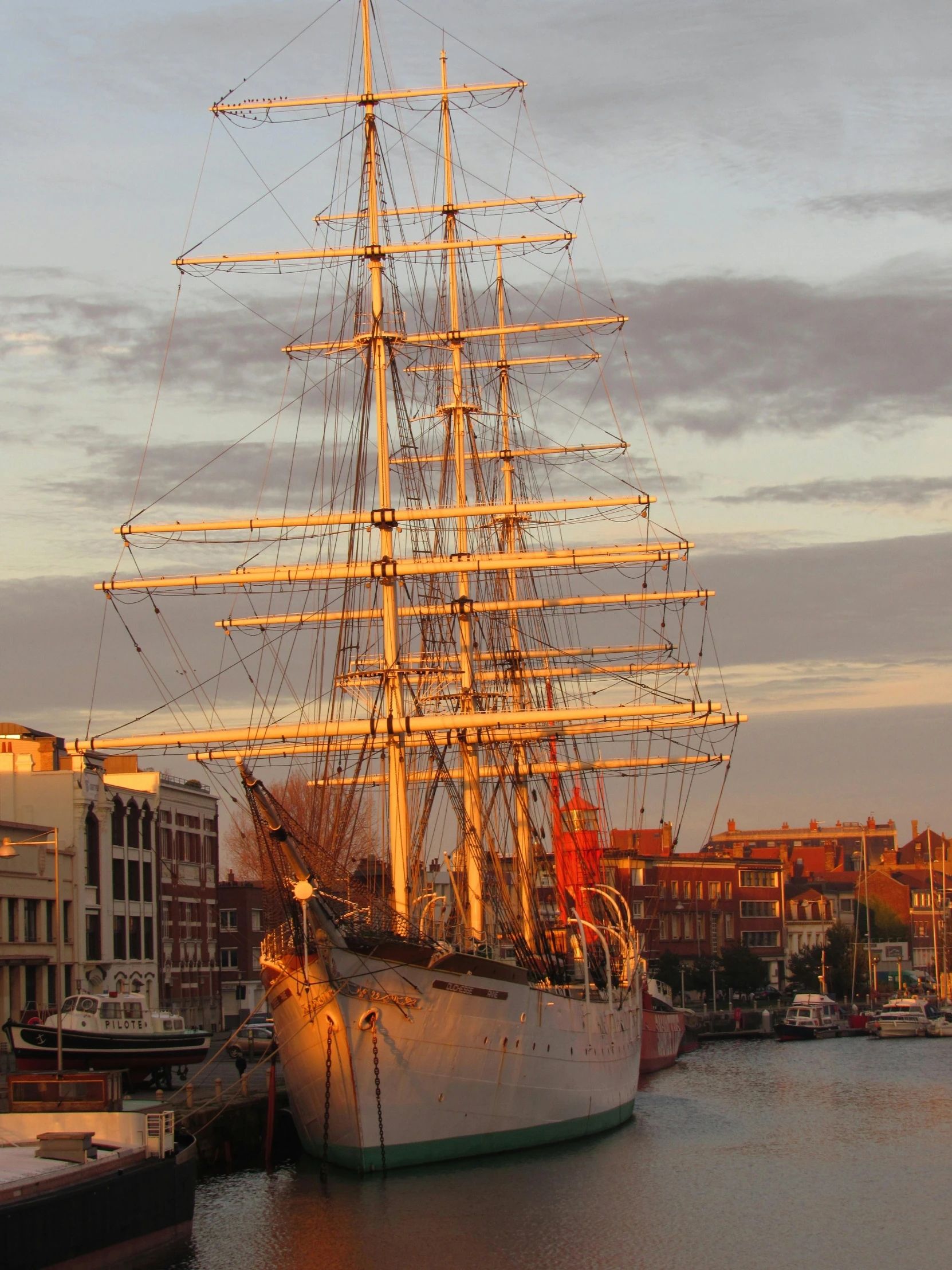 a big old fashioned sail boat docked in the harbor