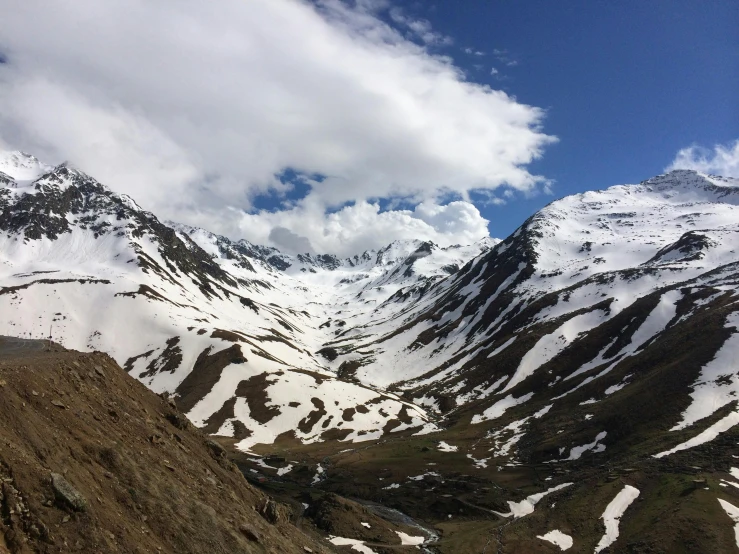 snow covered mountains on top of two different sides