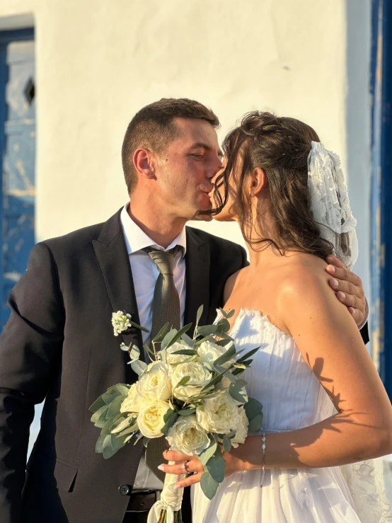 a newly married couple is kissing each other