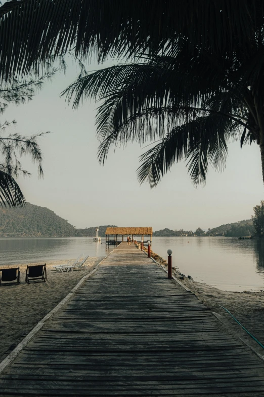 a view from the dock overlooking the water and mountains