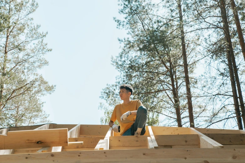 a young man sits on some steps outside