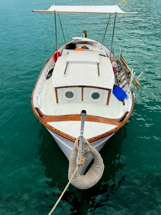 a boat in the sea surrounded by a line of other boats